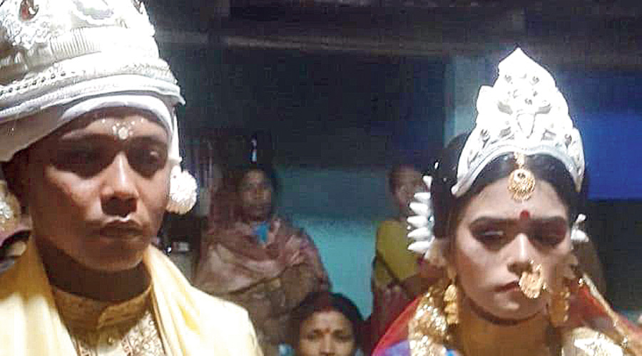 The newlyweds at Kumargram, Alipurduar,  on Monday night.