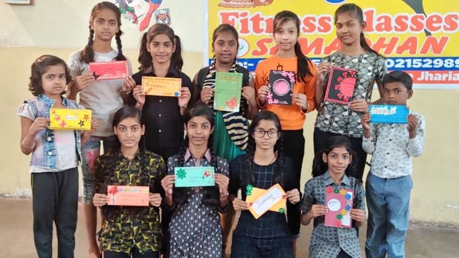 The children show invitation cards made by them in Jharia on Tuesday,