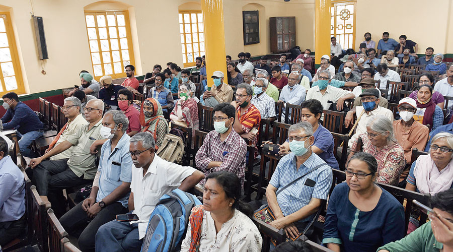 The audience listens to the speakers with rapt attention