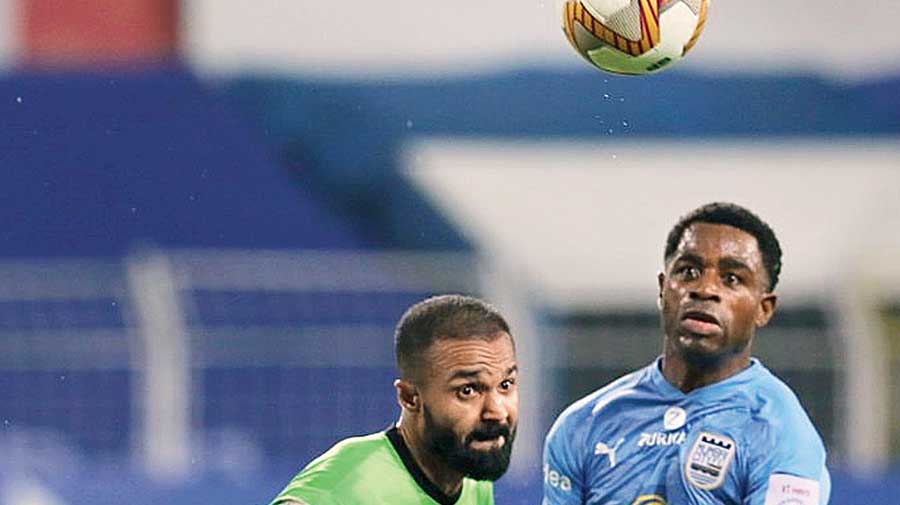 Arindam Bhattacharya (left) makes mess of a simple clearance as Bartholomew Ogbeche is all set to pounce on the ball on Saturday.