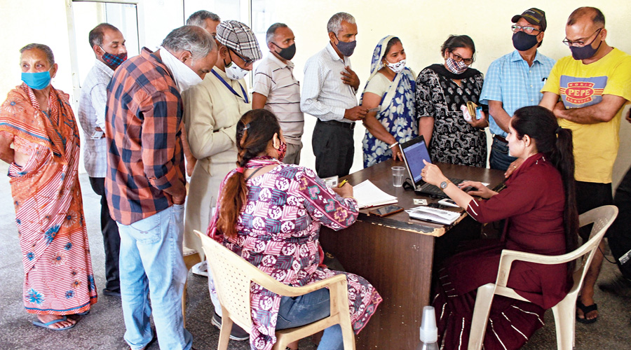 Senior citizens wait for their turn to receive their first dose of Covid-19 vaccine in Gurgaon on Tuesday.