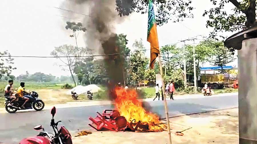 BJP supporters burn furniture and publicity materials in front of the party office in Karandighi of North Dinajpur on Friday. 