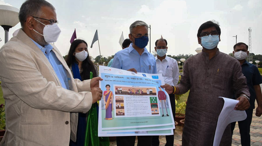 Chief Minister Hemant Soren along with other officials holding the guidelines about all aspects related to cleanliness, mid-day meal, toilet management and hygiene.