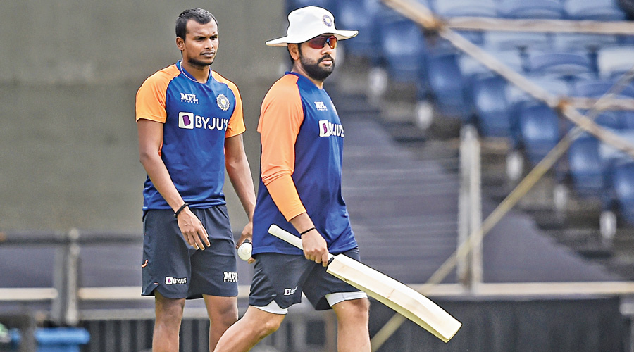 Rohit Sharma and T. Natarajan (left) at a practice session ahead of the first ODI against England in Pune on Monday.