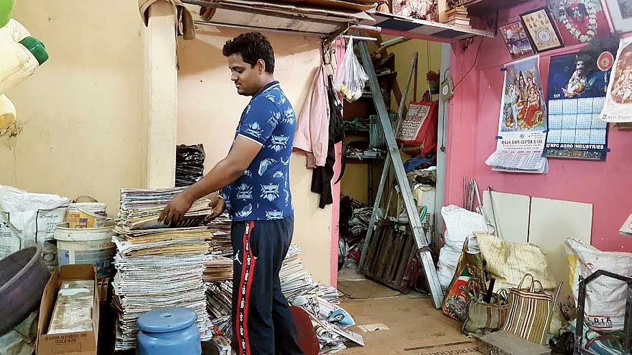 Amit Kumar Shaw weighs old newspaper bundles in BF Block.