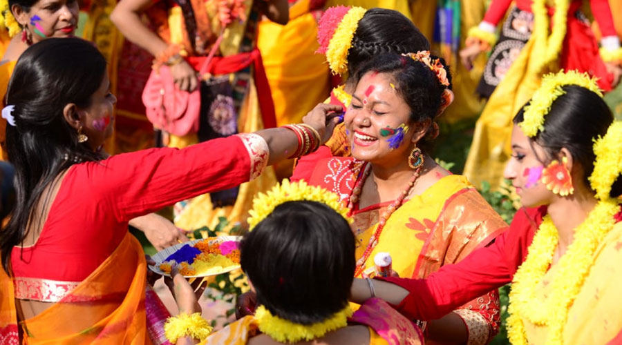 Members of Bengali Association smear gulal on each other.