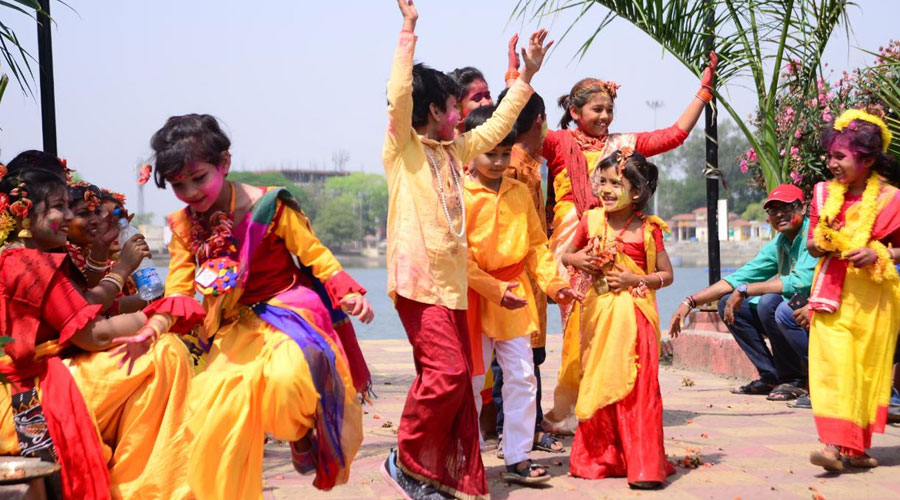Children dance and play holi