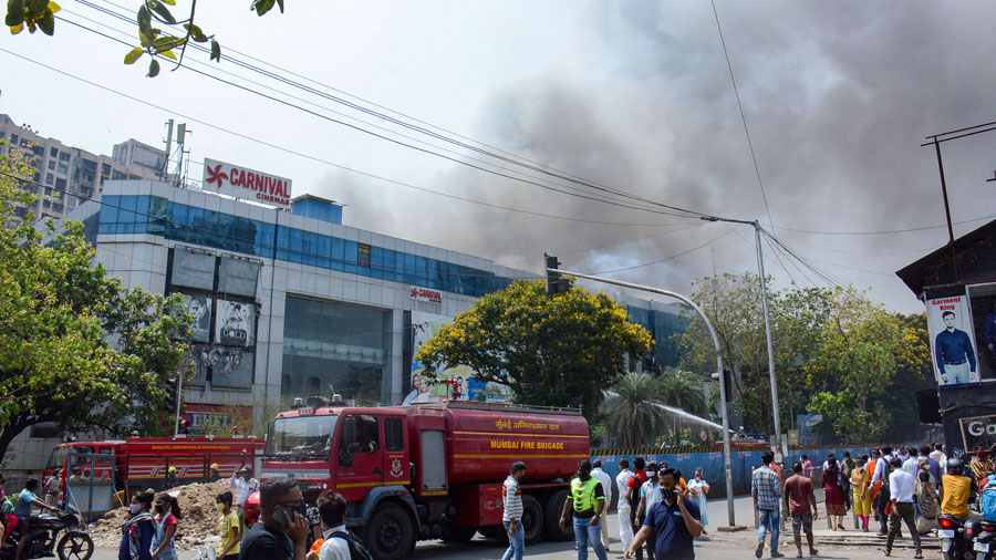 Firefighters attempt to douse a blaze at Dream Mall, affecting patients admitted in the nearby Covid-19 dedicated Sunrise Hospital, in Mumbai on Friday.