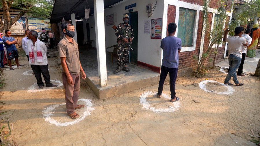  Voters queue up, maintaining social distancing, outside a polling station during the first phase of polling for Assam Assembly elections, at Amguri in Nagaon district on Saturday.