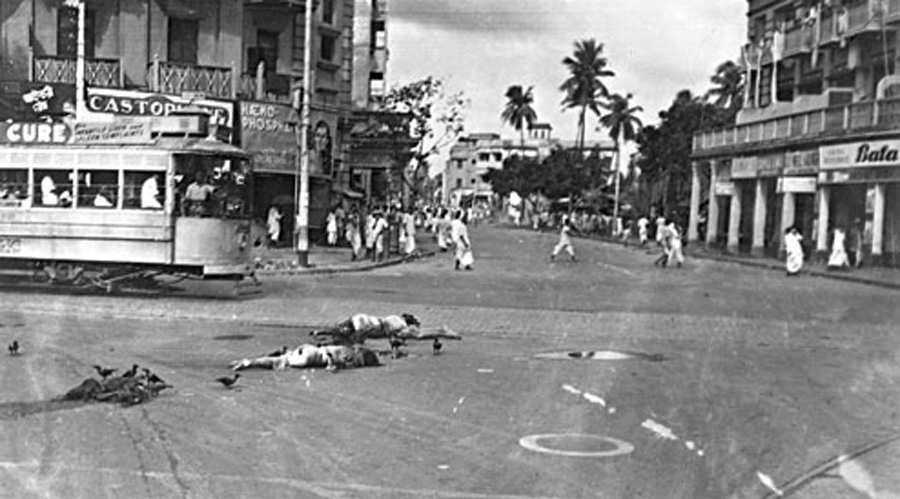 Life goes on as bodies lie on the streets of Bhowanipore after the 1946 riots.