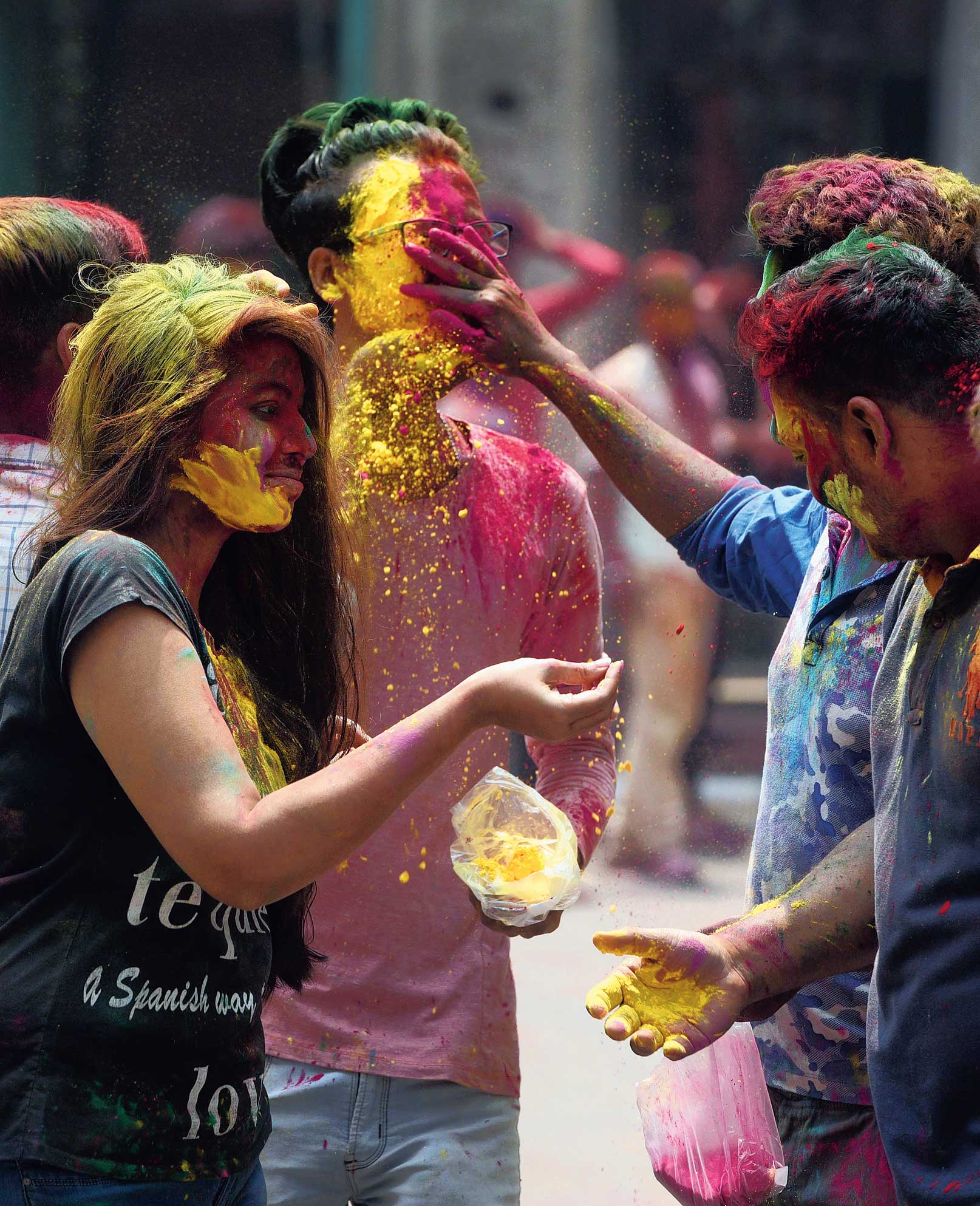 Youngsters smear abir on each other on Vivekananda Road