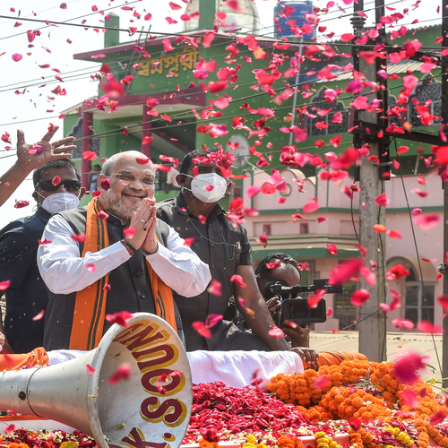 Amit Shah folds hands as he greets supporters at his Nandigram roadshow on Tuesday.