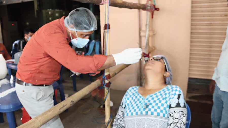 A health worker collects swab samples for Covid test from a counting agent in Burdwan on Friday.