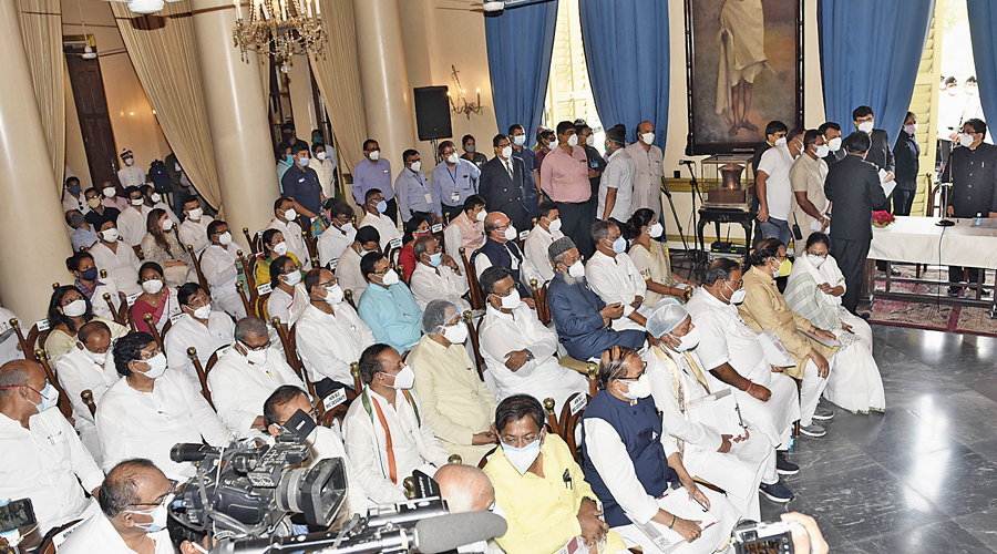 Mamata Banerjee with new ministers at the Raj Bhavan in Calcutta on Monday. 