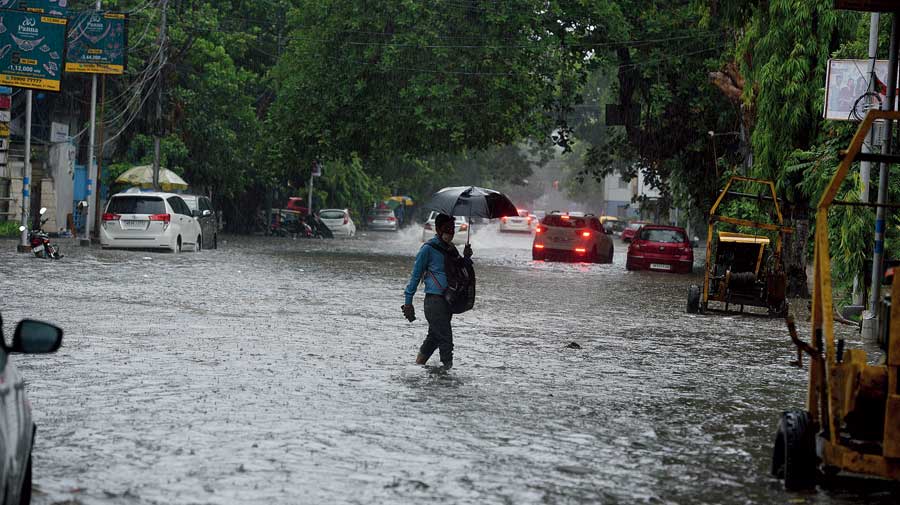 3.24pm: A man wades through waterlogged Camac Street on Tuesday