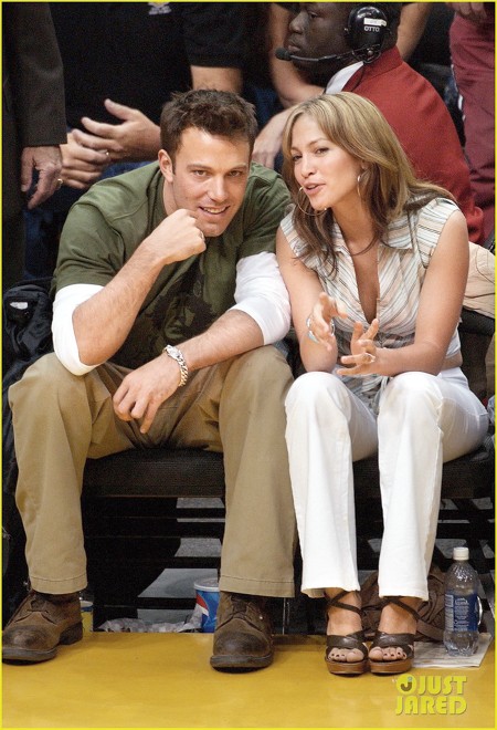 The couple at a basketball game just days before pushing back their wedding