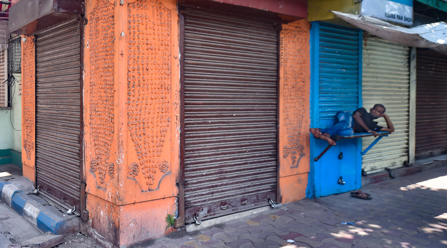 A man takes rest outside closed shops in Calcutta on Sunday. 