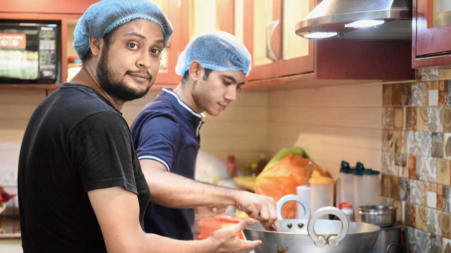 Abhisayan Ghara (in black) and Suhit Das at their Purna Das Road kitchen. 