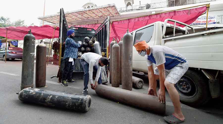 Sikh volunteers unload oxygen cylinders to support Covid-19 patients for free at a gurdwara in Indirapuram, Ghaziabad, on Tuesday