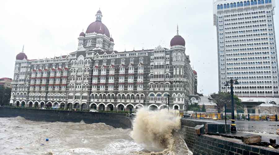 Waves crash near the Taj Mahal Palace in Mumbai on Tuesday in the aftermath of Cyclone Tauktae