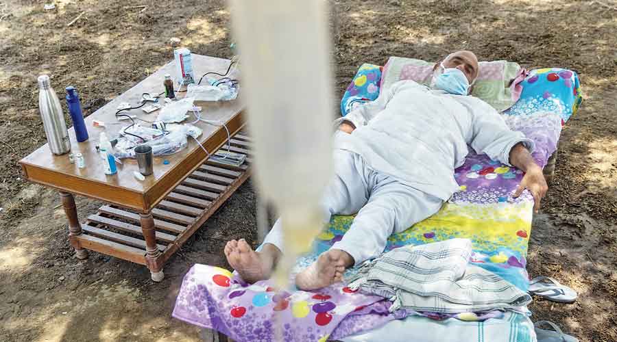 Covid patient Harveer Singh, 65, receives treatment at a makeshift open-air clinic in Mewla Gopalgarh village last week. 