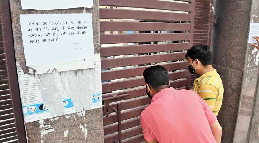 People at a closed vaccination centre in  New Delhi on Sunday