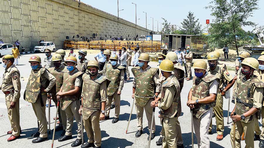 Police officers stand guard near the farmer  protest site at Delhi’s Ghazipur border on Wednesday. 