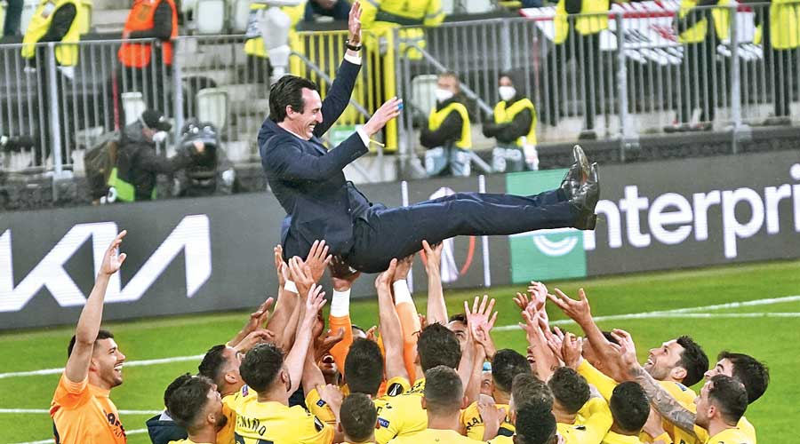 Villarreal’s players throw coach Unai Emery into the air as they celebrate  winning the Europa League final against Manchester  United in Gdansk, Poland.