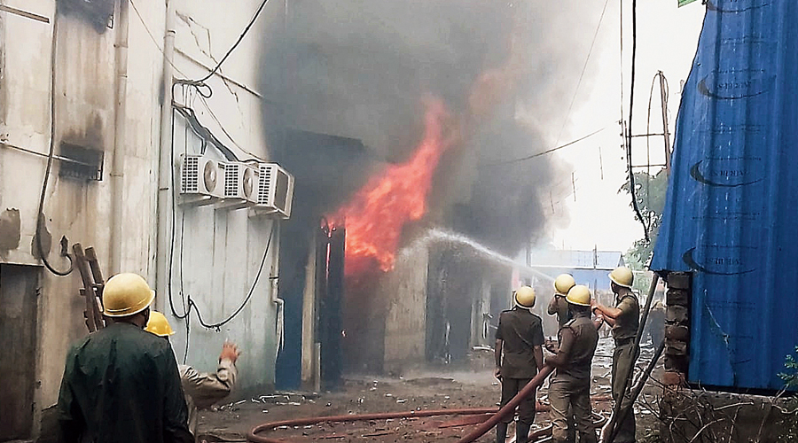 Fire brigade personnel try to douse the flames at New Barrackpore on Thursday morning.