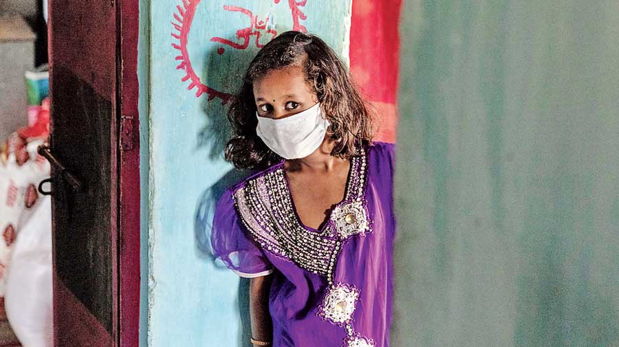 Suraj’s sister Ankita Kumari, 10, looks at their mother.