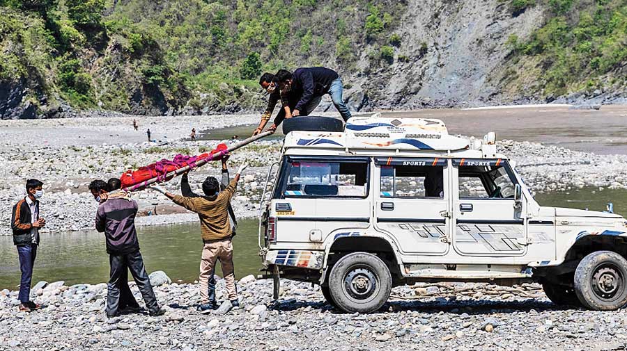 Pramila’s body is taken down for  cremation on the banks of the Ganga.