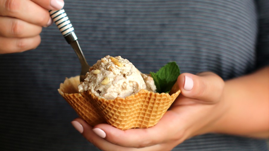 Vegan ice-cream with coconut milk and peanuts served in a waffle bowl 