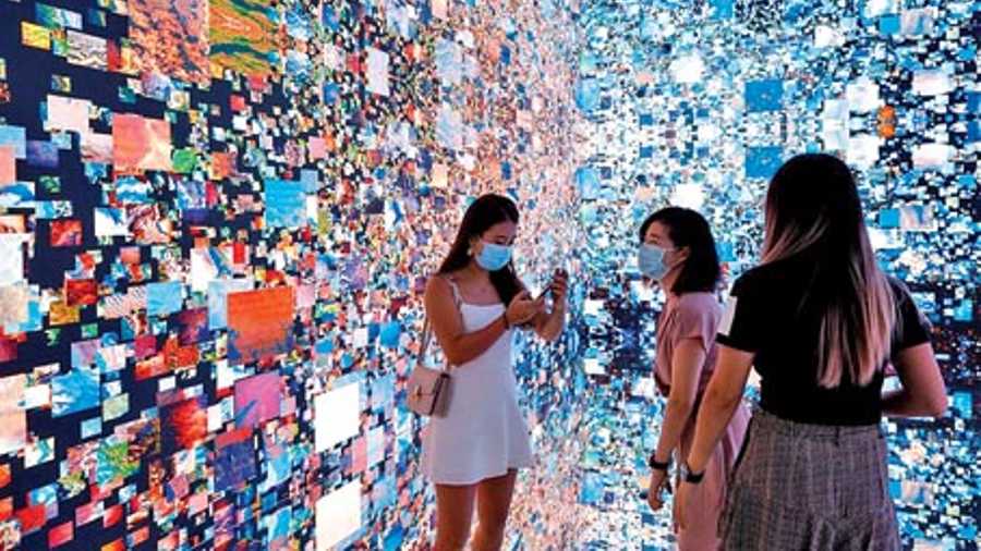 File picture of visitors pictured in front of an immersive art installation titled ‘Machine Hallucinations — Space: Metaverse’ by media artist Refik Anadol