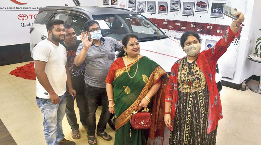 A family poses with the car they bought on  Dhanteras on Tuesday.