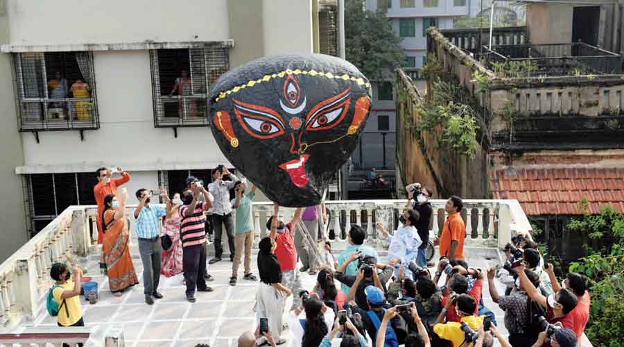 A hot air balloon being released from the terrace of a north Calcutta house
