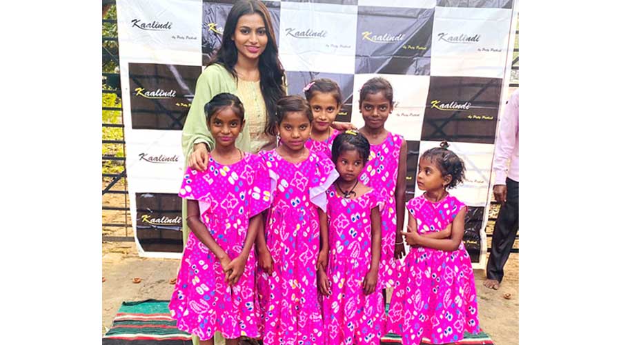 Children wearing Preity’s (in light green salwar-kamij) designed dress cheering with Preity Pathak