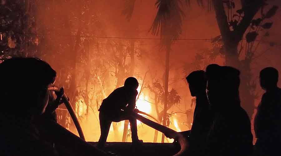 Firemen fight the blaze at a godown in Nadia district’s Santipur town on Thursday night.