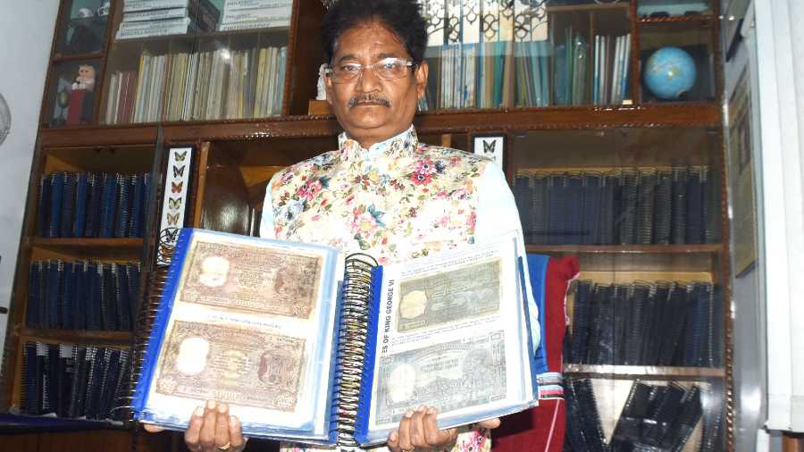 Amarendra Anand showing rare currency notes from his collection at his Kusum Vihar residence in Dhanbad on Monday.