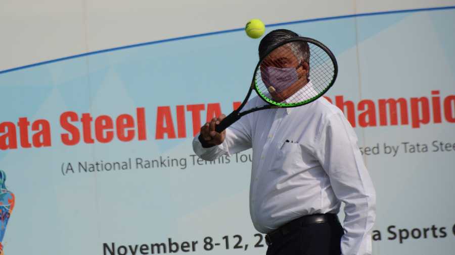  R.N. Murthy tries his hand in tennis while inaugurating the Tata Steel-AITA Championship Series in Jamshedpur on Monday. 
