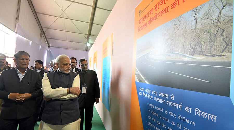 Prime Minister Narendra Modi visiting an exhibition during the launch of the Char Dham Rajmarg Vikas Pariyojana in Dehradun.
