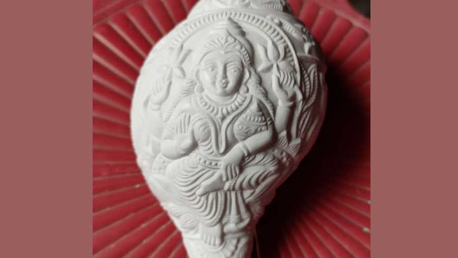 Goddess Lakshmi engraved on a conch shell
