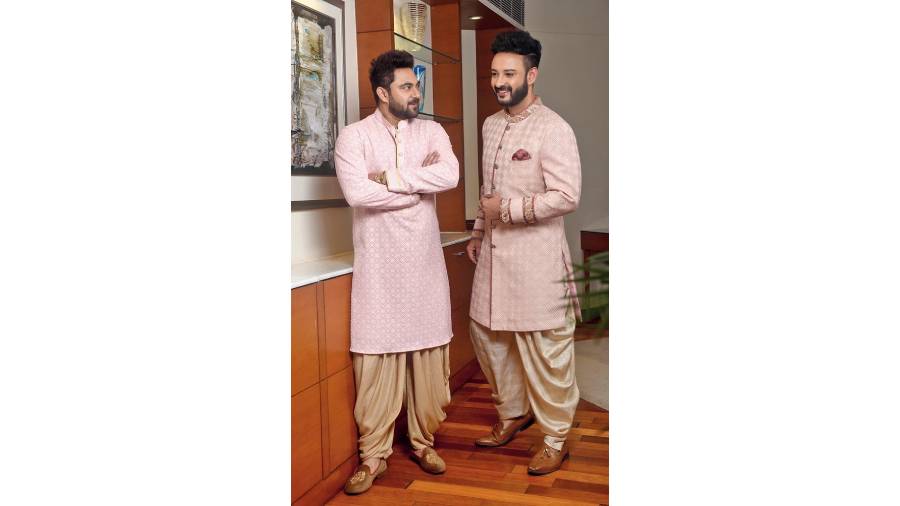 For the groom or the groom’s squad, this trendy peach nougat kurta on Soham with tone-on-tone resham embroidery and antique gold detailing around the cuff and buttons, paired with dull gold cowl Patiala pants, is perfect for the morning wedding functions or pre-wedding functions. “This outfit combines to form a vision of the dashing man in the new colour of the season — peach. The pants add softness to the silhouette,” said Jyotee Keep a hint of glam in your morning-to-evening wedding function look as with this soothing peach nou gat sherwani on Shaheb, paired with a pre-stitched dhoti detailed with gold zari. Perfect for a smart and trim ethnic look. “The subtlety of antique gold hand-embroidered border running along the collar and sleeves with pink brocade detailing leads the way for an understated but distinctive look. This resham-embroidered sherwani with antique gold palatial motifs paired with the dhoti is perfect for the millennial groom,” said the designer.