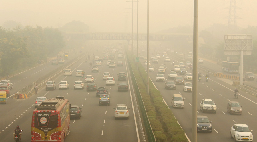 Vehicles ply amid low visibility due to a thick layer of smog at Delhi-Gurugram Expressway in Gurugram on Friday.