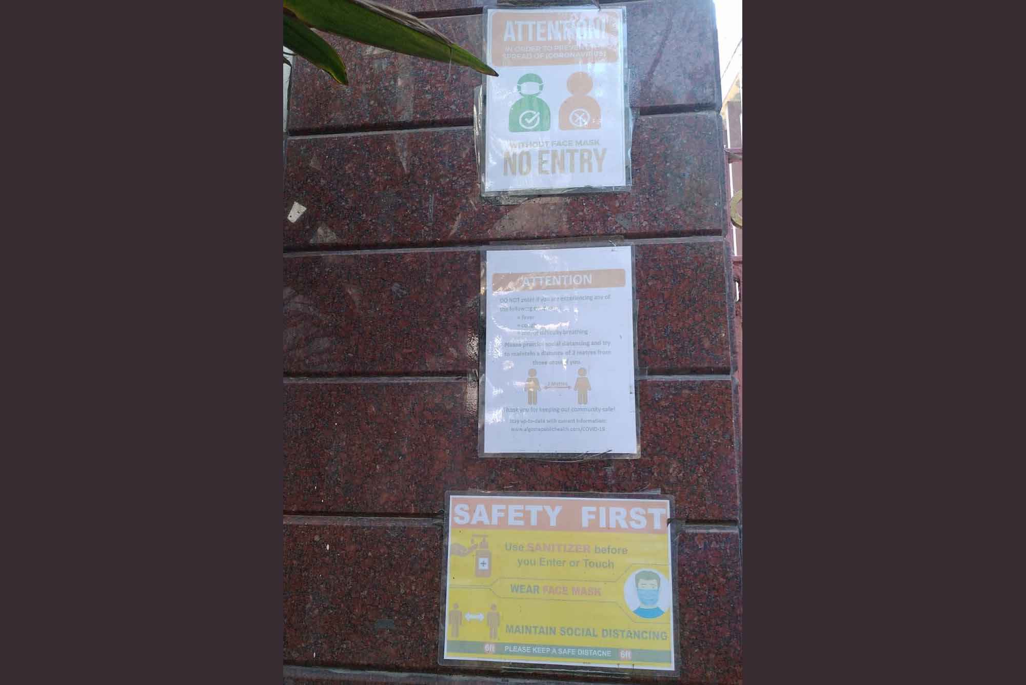 Notices at the school entrance reminding everyone about COVID-safety practices.