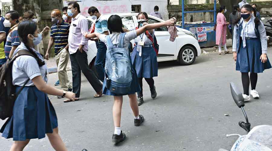 Students of Shri Shikshayatan Girls’ School greet each other as they arrive for the National Achievement Survey test on Friday morning.