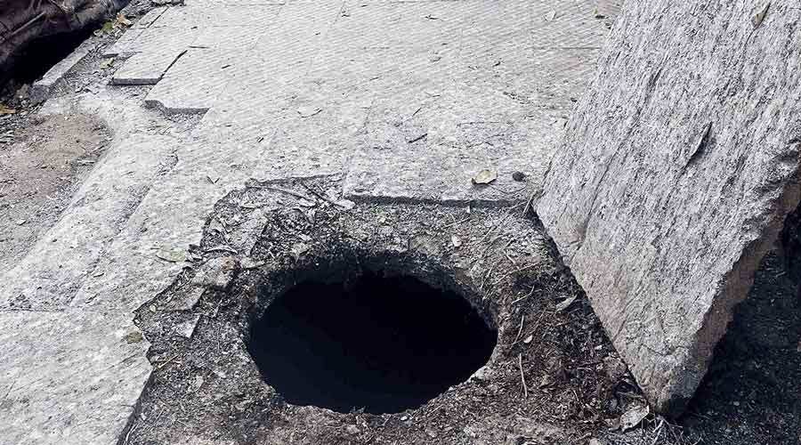 The open manhole in Dum Dum’s Seven Tanks area that Ranjan Saha fell into on Friday night.