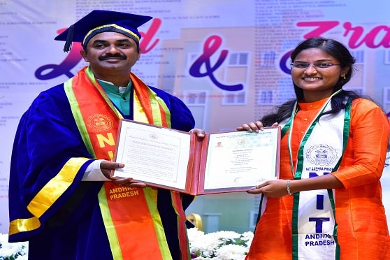 B. Anusha, topper of the 2017-21 batch of NIT Andhra Pradesh, receive the gold medal from DRDO chairman G. Satheesh Reddy at the convocation ceremony.