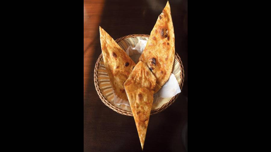 Gunpowder Naan: Hugely popular in South India and primarily made of dried chillies, gunpowder is the main ingredient of this dish. Unlike its name and look, however, these naans are not overwhelmingly spicy. They are soft, chewy, thin and an interesting take on the typical naan. Rs 75 (each)