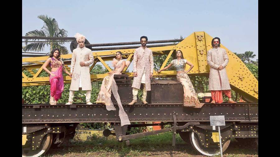 Brides and grooms, get your squads to amp up their style game by a notch for that perfect Insta-worthy frame. (L-R) On Anushka, a bright pink ombre cotton-satin pre-stitched dhoti sari paired with a cutwork fall and teamed with a leather embroidered and buckled blouse for an Indo-western look. Rangeet decked up in a coral pink sherwani detailed with threadwork and zardozi work. It has large floral motifs designed with dabka, paired with churidar and coral pink safa for a subtle-glam look. Arjama cut a pretty picture in a French-knotted crop top teamed with a digital-printed silk lehnga and sheer ruffled dupatta. On Neeraj, a hand-embroidered pink sherwani enhancing a silk kurta and beige churidar. Ankita channelled an effortless style in a digital-printed silk lehnga teamed with hand-embroidered corset and antique mukaish embroidered shrug. Kutub cut a spiffy pose in an achkan detailed with threadwork and teamed with a linen shibori pre-pleated dhoti.