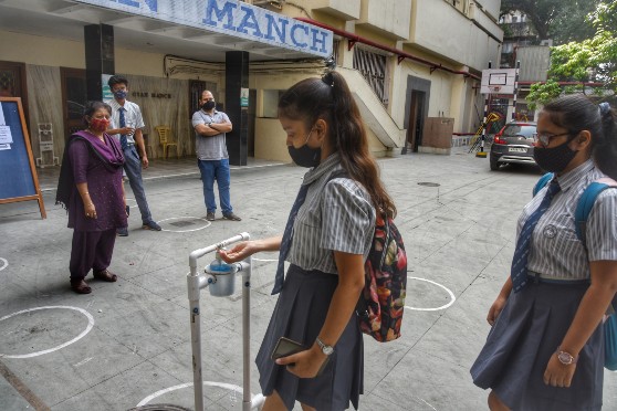 A contactless hand sanitiser stand greets students at the entrance to Abhinav Bharati High School. 